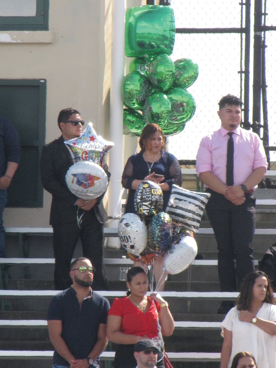 MESSAGE OF CONGRATULATIONS: Family members and friends of the Cranston East class of 2021 graduates brought balloons and signs to celebrate the occasion.